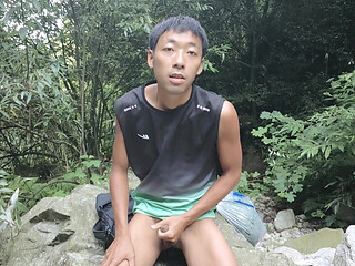 A wild boy masturbates, moaning and ejaculating by a stream in the deep mountains, and then eats his own semen