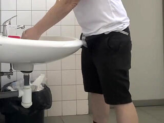 Guy Taking a Urine Sample in Hospital Toilets