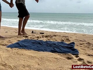 Beach Babe loses bet in public strip tic tac toe game
