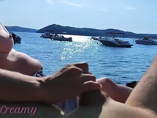 French MILF gives handjob on Greek beach, stranger cums all over