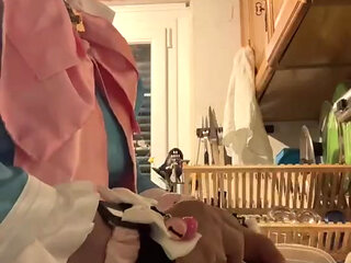 In a blue maid's outfit with pink bows to do the dishes.