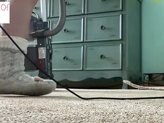 Woman in long sock vacuums with slipper socks