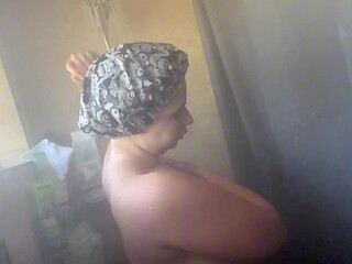 Chubby goth girl takes a steamy shower with big natural tits and a round ass.