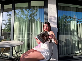Wonderfully beautiful girl in a summer dress no panties on the balcony shows her tight shaved pussy to the neighbors