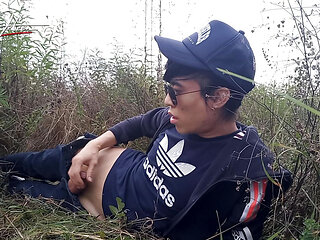 Cute gay Asian twink Jon Arteen speaks French wanks his smooth penis in the rain, lubricated with his saliva moans ejaculates
