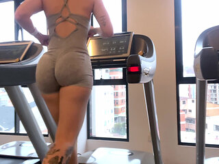 AT THE GYM: fitness girl with a big ass running on the treadmill