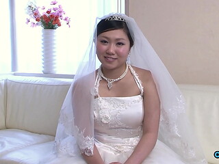 The new asian wife is still dressed in her wedding gown when someone visited her