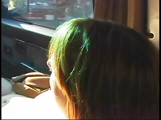 Commuter redhead carpools with creep who debases her in car in city traffic