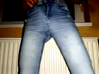 Amateur babe strips and gets a surprise huge cumshot on her torn blue jeans