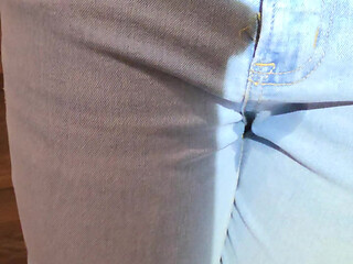 Desperately trying to hold but letting it all out in female light wash jeans