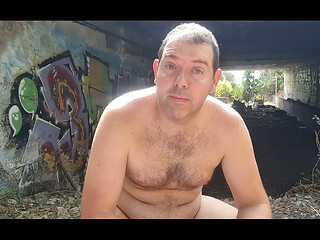 A boy completely naked near a tunnel