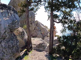 Outdoor Erotica, a Girl with a Stunning Figure Shows Her Magnificent Ass Against the Backdrop of the Sea and Mountains.