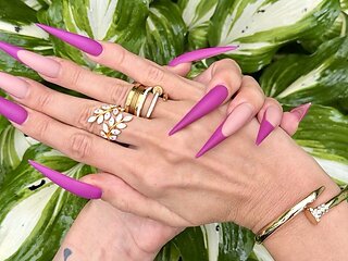 New Purple Color Long Nails, Sharp Stilettos, Palms, Long Fingers in the Garden with Flowers