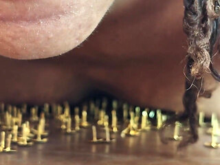 A Little Masochistic Submissive Lying on Thumbtacks