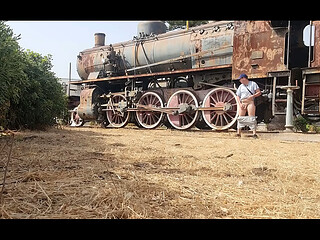 Nude near an antique train