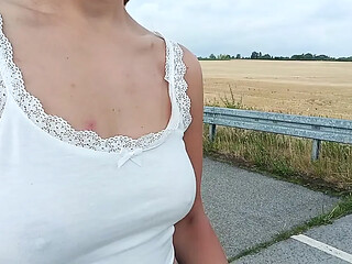 Naughty chick exposes her juicy pussy and perky tits on the street