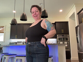 NIKKISFETISHES Tattooed woman in jeans bends over counter and poses on stool