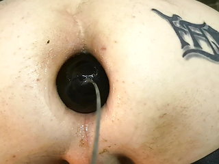 anal close-up insertion of a bakelite sphere with rod