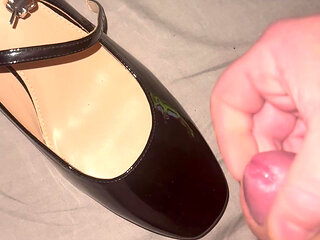 Cumming on black patent heels