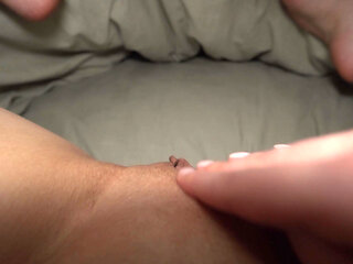 A girl masturbates her wet pussy under the blanket and moans sexily