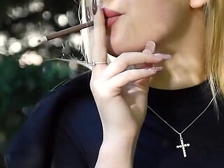 Hot Blonde Babe Smoking Two Black Cigarettes in Nature