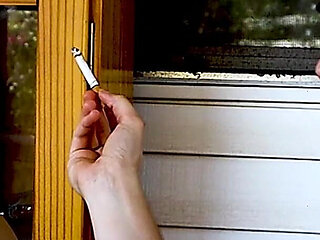 Shaved Head Goth Smokes Outside