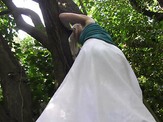 She climbs on tree and fingers her pussy