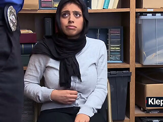 Hijab thief bends over desk so security won'_t call cops