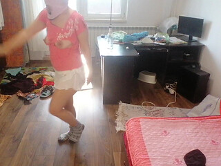Amateur woman has fun trying on clothes and cutting them.