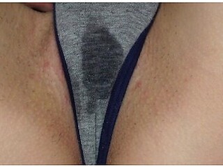 Wet panties betray her arousal as she touches herself