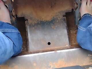 Barefooted babe rides bobcat tractor in public