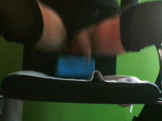 Riding 22 cm long dildo on chair in latex and heels.
