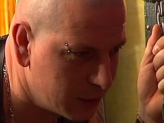 Tattooed Dom Fists Mature Blonde in Chains