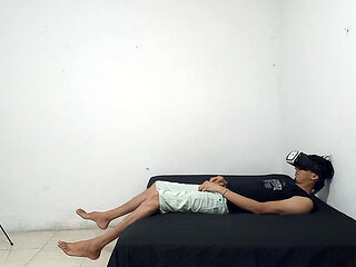 The skinny guy wants sex and puts on his virtual headset to masturbate his flaccid penis.
