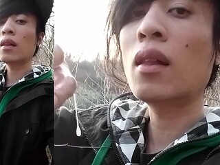 Outdoors, Jon Arteen masturbates his tumescent twink cock, ejaculates cum that sticks to his fingers and slowly drips.
