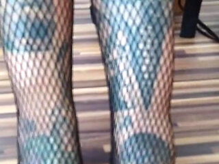 Tattooed lady in fishnet pantyhose