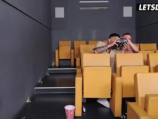 Tattooed MILF gets a standing fuck in movie theater