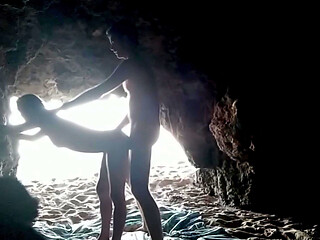 Couple recorded at the beach, inside the cave