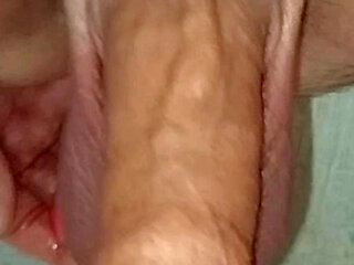 Horny uncut guy playing with long foreskin toys his anus and shoots cum