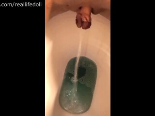 Petite girl pees in closeup