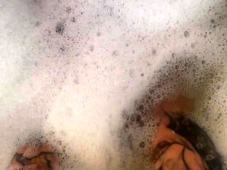 Tattooed MILF rubs oil on massive tits and feet before riding dildo