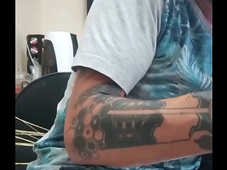 A m&atilde_o boba subindo devagar durante a sess&atilde_o de tatuagem