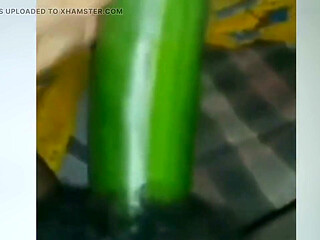 A Young Woman Is Inserting a Cucumber Into Her Pussy