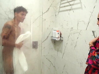 Big-assed stepmom ends up fucking her skinny stepson after spying on him in the shower