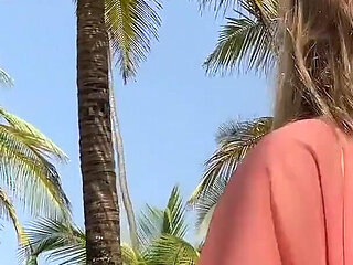 A Busty Blonde Woman Is Walking Around and Showing Her Naked Body on the Beach.