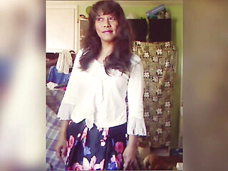 Jhazmeena wearing a white blouse and a pleated black retro flower print skirt