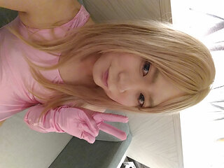 A blonde cross-dressing boy masturbated in a pink leotard, knee socks and gloves