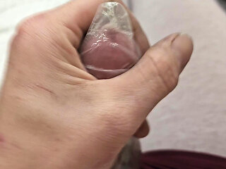 Edging in condom and finally relese a massive load inside!