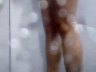 A very handsome young man starts taking a shower in the hotel, really nice with his big cock and body.