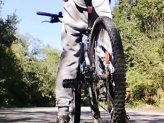 Slim boy with his bike in the park